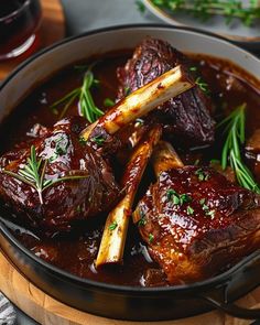 some meat and vegetables in a pot on a table