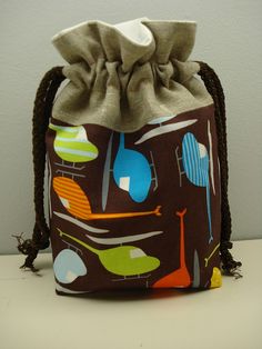 a drawstring bag sitting on top of a white table next to a wall