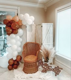 a chair and balloons in a room