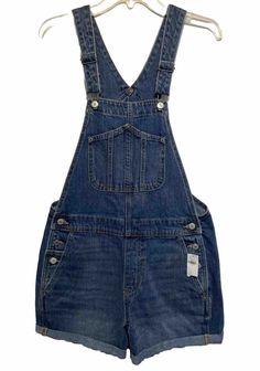 Get ready for summer with these stylish Old Navy blue denim slouchy jean shorts overalls! Made from 100% cotton denim fabric, these overalls feature a solid pattern with button closure and strap accents. The high-rise waist size is greater than 10.5 inches, while the waist size is 34 inches. The overalls have a slouchy fit and are designed for regular size women. These overalls are perfect for any American-themed event and can be easily cared for with their comfortable features. The inseam measures 4 inches, making them ideal for hot summer days. Add these denim overalls to your wardrobe today and enjoy their stylish and comfortable design. Jean Short Overalls, Slouchy Jeans, Denim Overalls, Overall Shorts, Denim Fabric, Jean Shorts, Old Navy, Blue Denim, Navy Blue