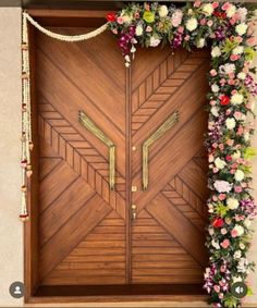 a wooden door decorated with flowers and garland