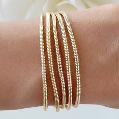 Attached layers Includes everything pictured Material: gold plated brass Length: 7" + 2" extension Everyday Gold Multi-strand Bracelets, Everyday Gold Brass Bracelets, Gold Multi-strand Stackable Bracelets, Gold Metal Bracelets For Layering, Gold Plated Flexible Chain Bracelet, Elegant Stacked Gold Bracelets, Elegant Gold Stacked Bracelets, Flexible Gold-plated Bracelet, Gold-plated Bracelet With Extender