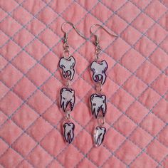 Hand drawn teeth illustrations on shrink dink plastic. Shrinkie Dink Ideas, Weird Jewelry Aesthetic, Shrinking Plastic Earrings, Shrinks Dink Earrings, Shrinks Dink Ideas, Cute Shrinky Dink Ideas, Shrink Plastic Ideas, Shrink Earrings, Shrink Plastic Charms