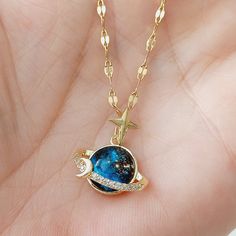 We are here with our blue celestial necklace with the theme of Saturn, the planet of Capricorn in our galaxy, space, moon and stars. You can gift this fun necklace with peace of mind, especially to your loved ones who are interested in astrology and to all your relatives who are Capricorns. Adding a flashy touch to your outfits with its blue planet design, our pendant has a thin and dainty chain. The thin chain design exudes an aesthetic and contemporary feel, making it a versatile, statement-ma Space Theme Jewelry, Saturn Pendant, Moon Star Necklace, Saturn Necklace, Planet Design, Blue Planet, Celestial Necklace, Blue Space, Dainty Chain