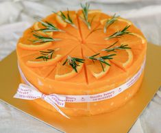 a cake decorated with orange slices and rosemary