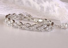 "'Felicity' Crystal Bridal Bracelet has been designed in a triple marquise style and will let your beautiful engagement and wedding rings take center stage. The CZ crystals are very high quality and look just like the real thing without the 'real' price tag. The sparkle on these is incredible. Set in a rhodium tarnish resistant base, Felicity is heirloom quality and can be worn again and again. We have closed it with a rhodium lobster clasp and small extender complete with a matching crystal for Luxury White Bracelet For Engagement, Luxury White Gold Bracelets For Engagement, Luxury Faceted Bracelets For Wedding, Favorite Engagement Rings, Engagement And Wedding Rings, Choker Designs, Bracelet Crystal, Bracelets Gold Diamond, Wedding Jewelry Bracelets