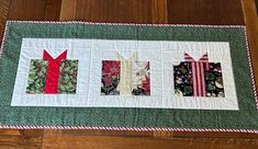 a quilted table runner with four different pieces of fabric on the top and bottom