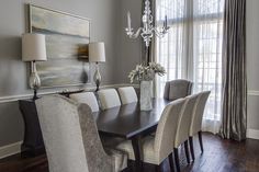 a dining room table with chairs and a chandelier