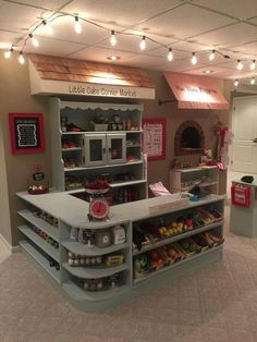 the inside of a small store with lots of food on display and lights hanging from the ceiling