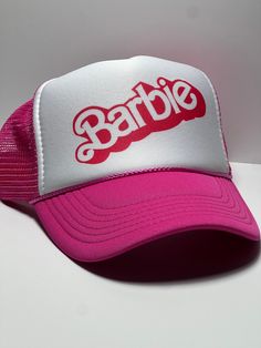 Vintage  Barbie Trucker Mesh Hat Snap Back Cap Pink Vintage Trucker Style hat, Retro snapback hat, appears unworn and brand new This is a mesh trucker hat with an adjustable snapback that fits most people 100% Polyester Front 100% Nylon Mesh Back 5-panel cap Seamless Foam Front Panel with Lining 6 Rows of Stitching on the Visor Matching Fabric Under visor Adjustable Plastic Snap Snap Back Cap, Vintage Trucker Hats, Mesh Hat, Hats Snapback, Snap Back, Snap Backs, Snapback Cap, Vintage Barbie, Trucker Hats