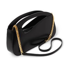 The Iconic Large Signature Curve Handbag has a unique curve shaped integral handle. A stylish and elegant magnetic roll top closure that can be worn over your shoulder, as a cross-body bag, or as a hand held handbag. Expertly hand crafted from the very finest deep black Italian calf leather. Comes with a internal zip pocket along with an additional card holder double slip pocket. Six protective metal feet at base.Detachable chain and leather strap with a 50cm drop.Designed in London, Made in Flo Modern Satchel With Chain Strap Tote, Modern Satchel With Chain Strap, Modern Tote Satchel With Chain Strap, Chic Baguette Bag With Round Top Carry Handle, Chic Baguette Bag With Top Round Handle, Modern Crossbody Baguette Bag With Chain Strap, Chic Rectangular Baguette Bag With Chain Strap, Modern Baguette Bag With Chain Strap Crossbody, Luxury Baguette Bag With Chain Strap For Everyday Use