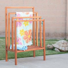 a towel rack sitting on the side of a sidewalk next to a tortoise shell