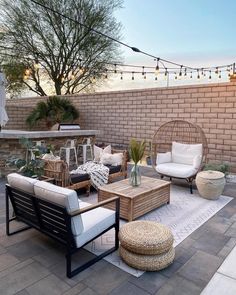 an outdoor patio with wicker furniture and string lights