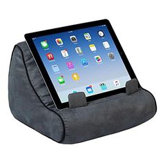 an ipad sitting on top of a pillow with its holder attached to the back of it