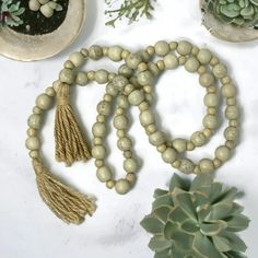 a white table topped with plants and beads