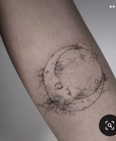 a tattoo on the arm of a woman with a crescent moon and stars above her head