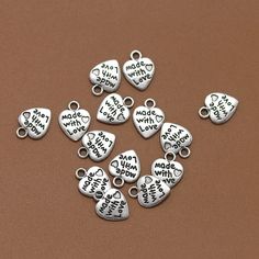 50pcs 12x9mm Antique Silver Made with Love Heart Tags Charm Pendants ❤ Collect them for creating you own style!  ❤ Material: Zinc Alloy ❤ Color: Antique silver antique bronze ❤ Size:   12x9mm  ❤ QTY: 50pcs ❤Want to see more? please click on http://www.etsy.com/shop/Jimmyaccessories Any questions please do not hesitate to contact me :) Personalized Heart Charms For Birthday, Heart-shaped Charms For Valentine's Day Jewelry Making, Nickel Free Heart Charms For Valentine's Day, Heart Charms For Jewelry Making Valentine's Day, Nickel-free Heart Charms For Valentine's Day, Heart Charms For Jewelry Making On Valentine's Day, Silver Heart Charms For Birthday, Heart Tag, Valentin Nap