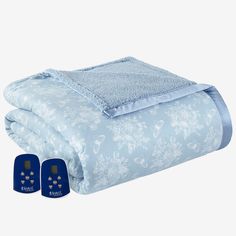 a blue blanket and two pillows on top of each other