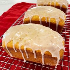 three glazed donuts sitting on top of a cooling rack