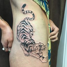 a woman with a tiger tattoo on her stomach