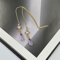 ❤️Deliver gifts on time with our recommended ship-by dates.❤️ - 16 DEC USPS first class mail - 18 DEC USPS Priority mail - 20 DEC USPS Priority mail express These are simple and beautiful teardrop crystal earrings. Purple crystals are framed in bright gold and dangling from long thread.  Measurements: The total length from the top of the hook to bottom - 4.13 inches (105 mm) approximately. Connector crystal: 5 mm x 5 mm Crystals: 12 mm x 4 mm These earrings would be a PERFECT GIFT for you and your family and friends!  Click here to see more Modern Everyday Earrings: https://www.etsy.com/shop/GrigorevaK?ref=seller-platform-mcnav§ion_id=27174357 Thank you for your visit! Soft Purple Thread Earrings, Purple Teardrop Earrings, Tiny Purple Earrings, Purple Wedding Earrings, Purple Thread Earrin Gold And Purple Earrings, Haldi Outfit, Thread Earrings, Earrings Purple, Jade Earrings, Purple Earrings, Fancy Jewellery, Ear Piercing, Ear Rings