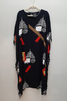 Fantastic vintage 1990s kaftan dress from Shopping with Anthony. One Size fit, likely working for a Medium - 3X.  Modernist funky art-to-wear print, all fringed on side, with open armholes and side vents on side bottom hem. 100% Rayon.  Hand wash or dry clean.  In excellent condition!  MEASUREMENTS:   80" bust 41" across top shoulder  50" length 83" waist/hips  NOTE:   Shipping to USA only! Traditional Black Printed Kaftan, Black Printed Kaftan For Festival, Vintage Black Printed Dress, Bohemian Maxi Dress With Graphic Print, Bohemian Dresses With Graphic Print, Black Printed Tunic Kaftan, Bohemian Graphic Print Maxi Dress For Beach, Black Kaftan Dress, Gulfport Ms