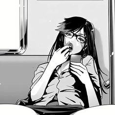 a woman sitting on a train looking at her cell phone