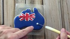 someone is decorating a cookie with the flag of australia