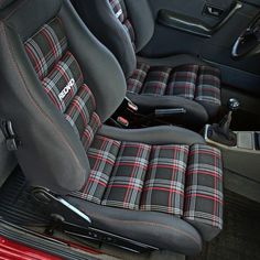 the interior of a car with black and red plaid seat covers on it's seats