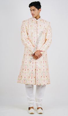 This item is made specially for you by hands with love  Item contains : Sherwani Kurta Pyjama & Shoes  Fabrics :   Silk Colours :  Pink  Style and Designs :  Sherwani and kurta have mandarin collar and long sleeves with a full button placket symmetric hem and multiple slits  It's has all over resham thread embroidery and hand embroidered with multi color thread used collar and buttons with a touch of hand work   White coloured solid churidar has a drawstring closure with nara  Shoes is made of the same fabric as sherwani and also embroidered with same work all to look like a gesture  Size :  Slim fit  Model height is 6 fit and wearing 40 size  Material and Care :  Polyester mix  Only dry clean  Note :  There might be slightly changes in colours as effect of light and photography Cut a dash House Clothes, Kurta With Pants, Churidar, Wedding Suits Men, Nara, Pink Silk, Mandarin Collar, Pink Fashion, Wedding Suits