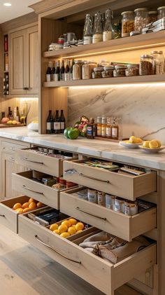 an open drawer in a kitchen filled with lots of food and drinks on the counter