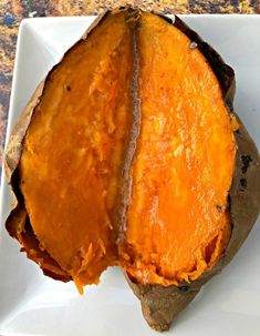 a baked sweet potato sitting on top of a white plate