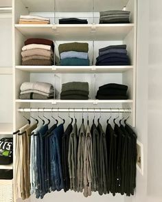 an organized closet with folded shirts and pants