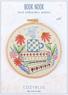 the book nook hand embroidery pattern is displayed in front of a white background with flowers and