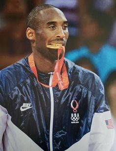 a man with an olympic medal in his mouth