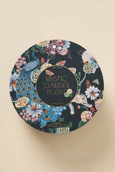 the mystic garden puzzle is on display in front of a white wall and beige background