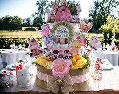 there is a cake that has been decorated with farm animals and flowers on the table