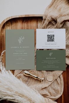 the wedding stationery is laid out on a wooden tray with fur and gold accents