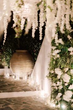 an outdoor ceremony with white flowers and candles