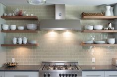 an image of a kitchen with shelves above the stove