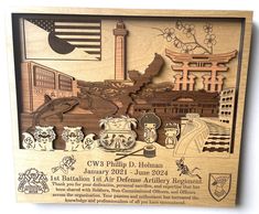 a wooden plaque with an image of the united states and its landmarks on it, in front of a white background