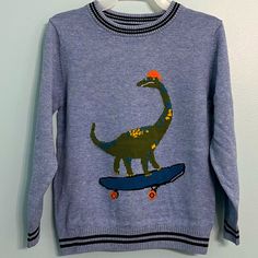 Listed Is A Brand New Dinosaur Sweater! This Is A Boutique Brand From Great Britain And A Great Quality Product. Details: - Joules Brand - Boys Size 5 Year - Light Blue In Color With Navy Trim And Skateboarding Dinosaur Front And Center - Knitted Intarsia Artwork Jumper - Crew Neck - Long Sleeve With Ribbing To The Neck, Cuffs And Hem - Contrasting Tipping - Embroidered Hare - Made Of 100% Cotton - Retails For $48 Ships From A Smoke-Free Home! Skateboarding Dinosaur, Bug Sweater, Dino Sweater, Embroidered Hare, Film Night, Dinosaur Sweater, Patchwork Sweatshirt, Holiday Inspo, Patchwork Clothes