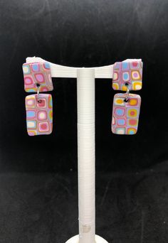 These awesome retro style earrings are lightweight and each pair is completely unique! These funky earrings are made from polymer clay with surgical stainless steel posts. Retro Multicolor Drop Earrings, Retro Dangle Earrings For Pierced Ears, Retro Multicolor Jewelry With Matching Earrings, Modern Multicolor Earrings With Bold Design, Modern Pink Rectangular Earrings, Vintage Multicolor Drop Clip-on Earrings, Retro Handmade Drop Earrings, Retro Dangle Jewelry, Handmade Retro Dangle Earrings