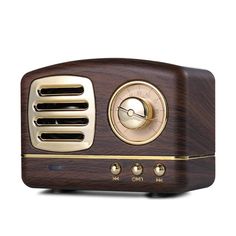 an old fashioned wooden radio with gold trim