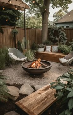 an outdoor fire pit surrounded by chairs and trees