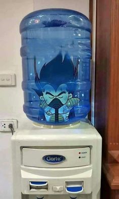 a water cooler sitting on top of a counter next to a wall with a cartoon character painted on it