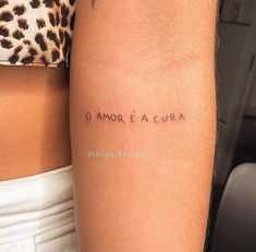 a couple of people with tattoos on their arms and one has the words o amo e acura