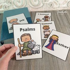 a hand holding four cards with pictures of jesus and the shepherd