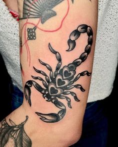 a woman's arm with a crab tattoo on it