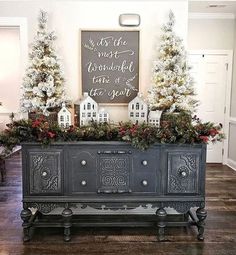 an old dresser is decorated with christmas trees and garlands for the holiday decorating